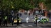 FILE - Police forensics officers work at a site cordoned with police tape, following a major incident in Nottingham city centre, Nottingham, Britain, June 13, 2023. 