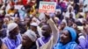 A man holds up a sign that reads 'vote no on the referendum' during a march against the new constitution organized by the Association of Imams, in Bamako, on June 16, 2023. 