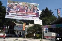 FILE - View of a billboard advertising governor candidate Delfina Gomez in the municipality of Ocoyoacac, State of Mexico, May 22, 2023.