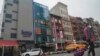FILE - A six-story glass facade building, pictured second from left in New York's Chinatown, April 17, 2023, is believed to be the site of a foreign police outpost for China. On June 6, 2023, U.K. officials said China had closed similar stations across the nation. 