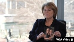 Карла Веббер, мати вбитого в Україні американського ветерана Ендрю Веббера, показує фото свого сина та його дружини.