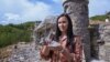 Marija Milicevic holds a stone used to decorate the hobbit house named "Bedem", in the Bosnian Hobbiton village, Rakova Noga, Bosnia and Herzegovina, May 9, 2023. 