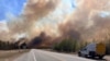 Smoke column rises from a wildfire near Wildwood, Alberta, Canada, May 5, 2023. 