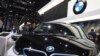 FILE - A worker cleans an electric vehicle at the BMW booth during the Auto Shanghai 2019 show in Shanghai, Apr. 17, 2019. BMW was recalling more than 1.3 million vehicles in China that might have Takata airbag inflators.