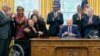 Interior Secretary Deb Haaland hugs Sen. Tammy Duckworth, D-Ill., after President Joe Biden, joined by civil rights leaders and elected officials, signs a proclamation in the Oval Office, Aug. 16, 2024, to designate the Springfield 1908 Race Riot National Monument. 