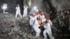 FILE - This photo taken early on May 5, 2022 shows rescuers carrying a survivor out of a collapsed six-story building in Changsha, central China's Hunan province. (Photo by CNS / AFP)