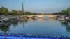 FILE - Athletes dive into the Seine River from the Alexander III bridge on the start of the first leg of the women's triathlon test event for the 2024 Paris Olympics in Paris, Aug. 17, 2023. 
