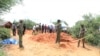 FILE - Police officers are exhuming bodies of victims of a Christian cult that has led to the deaths of hundreds of followers, at a forest near Malindi town, Kenya, April 25, 2023.