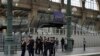 FILE - Police officers patrol inside the Gare du Nord train station at the 2024 Summer Olympics, July 26, 2024, in Paris, France. The French government says multiple telecommunications lines have been hit by acts of vandalism. 