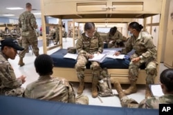 FILE - Students enlisted in the new Army prep course work together in the barracks at Fort Jackson in Columbia, South Carolina, on Aug. 26, 2022.