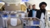 FILE - Badruddin Haqqani, right, then the Afghan Taliban envoy to the United Arab Emirates, walks through an aircraft displayed at the Dubai Air Show in the UAE, Nov. 13, 2023. The UAE on Aug. 21, 2024, accepted Haqqani's credentials as ambassador.