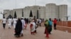 People gather outside the parliament building, a day after the resignation of Bangladeshi Prime Minister Sheikh Hasina, in Dhaka, Bangladesh, Aug. 6, 2024.