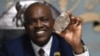 Botswana's President Mokgweetsi Masisi holds a large diamond discovered in his country, at his office in Gaborone, Aug. 22, 2024.