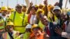 FILE - Ward 8 Councilmember Trayon White, Sr., right, and others pose for a photo after a ceremony to open the new Frederick Douglass Memorial Bridge in Washington, D.C., Sept. 7, 2021.