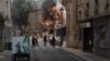 Smoke billows from the rubble of a building at Place Alphonse-Laveran in the 5th arrondissement of Paris, June 21, 2023. Witnesses told BFM TV there had been a strong smell of gas moments before the blast.