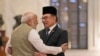 Indian Prime Minister Narendra Modi, left, welcomes his Malaysian counterpart Anwar Ibrahim upon his arrival at the Indian presidential palace during his ceremonial reception in New Delhi, Aug. 20, 2024.