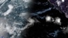This satellite image provided by the National Oceanic and Atmospheric Administration (NOAA) shows Tropical Storm Hone and Hurricane Gilma located southeast of Hawaii, Aug. 22, 2024. (NOAA via AP)