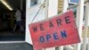 A sign hangs on the front door of Kingdom Trails in Burke, Vt., Aug. 14, 2024. Storms that hit the region on July 10 and July 30 washed away some roads and bridges, damaged homes and trails, and discouraged visitors at the height of the season.