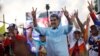 Venezuelan President Nicolas Maduro flashes victory hand signs at supporters during a pro-government rally, in Caracas, Venezuela, Aug. 17, 2024. 