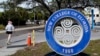 FILE - A student makes her way past the sign at New College of Florida, Jan. 20, 2023, in Sarasota, Fla. 