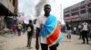 An anti-government demonstrator wears a Democratic Republic of Congo flag as he takes part in a riot in Kinshasa, Democratic Republic of Congo, May 20, 2023.