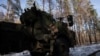 Seorang prajurit brigade artileri terpisah ke-45 Ukraina turun dari kokpit sistem howitzer self-propelled Archer buatan Swedia di hutan di wilayah Donetsk, di tengah serangan Rusia ke Ukraina, 16 Desember 2023. (Foto: REUTERS/Thomas Peter)