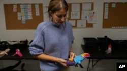 Andrea Cukerman, an electrical engineer and founder and of Manos de Héroes, or Hands of Heroes, explains how their prosthetic hands work at the foundation’s headquarters in Montevideo, Uruguay, April 14, 2023.