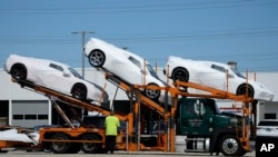 New Corvettes are delivered to a Chevrolet dealer in Wheeling, Ill., Tuesday, May 9, 2023.