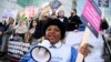 FILE - A person uses a megaphone as nurses protest during a strike by NHS medical workers, amid a dispute with the government over pay, outside University College London Hospital in London, Britain, Feb. 6, 2023.