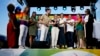 French Sports Minister Amelie Oudea-Castera, center, in dark skirt, takes part in the opening of Pride House, a safe space for the LGBTQ+ community of athletes, during the 2024 Summer Olympics, in Paris, France, July 29, 2024. 