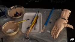 A prosthetic hand made with a 3D printer sits before being painted at the Manos de Heroes foundation headquarters in downtown Montevideo, Uruguay, April 14, 2023.