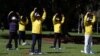 FILE - Falun Gong members exercise in Sydney, Australia, Aug. 28, 2020. Two Los Angeles residents have been charged with acting in a Beijing-directed scheme targeting U.S.-based practitioners of the Falun Gong group, which is outlawed in China.