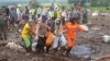 FILE - Rescuers carry the body of a victim of a flash flood in Tanah Datar, West Sumatra, Indonesia, on May 13, 2024.