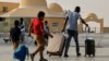 Passengers fleeing war-torn Sudan cross into Egypt through the Argeen Land Port on May 12, 2023.