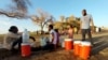 Citizens dig small holes at the shore to get pure water at the banks of the White Nile as clashes between the Paramilitary Rapid Support Forces and the Sudanese army continue, in Khartoum, May 6, 2023.