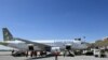 Sejumlah karyawan menurunkan koper-koper dari bagasi pesawat yang baru tiba di Bandara Aleppo, Suriah, 11 Maret 2023 sehari setelah dibuka kembali menyusul serangan Israel pada 7 Maret. (Foto: AFP)