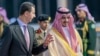 In this photo provided by Saudi Press Agency, SPA, Syrian President Bashar Assad, is accompanied by Prince Badr Bin Sultan, deputy governor of Mecca, May 18, 2023, ahead of the Arab summit. 