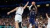 LeBron James, right, of the United States, shoots as Filip Petrusev, of Serbia, defends in a men's basketball game at the 2024 Summer Olympics, in Villeneuve-d'Ascq, France, July 28, 2024. 