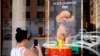 The new Dolce and Gabbana dog perfume called "Fefe" in honor of Domenico Dolce's dog and released earlier this month is displayed on the shop window of the fashion brand boutique in Rome, Aug. 6, 2024. 