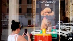 The new Dolce and Gabbana dog perfume called "Fefe" in honor of Domenico Dolce's dog and released earlier this month is displayed on the shop window of the fashion brand boutique in Rome, Aug. 6, 2024. 
