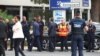 France's Prime Minister, Gabriel Attal, center left, France's Minister for the Interior and Overseas Gerald Darmanin, center right, shake hands with firefighters as they arrive at the site of a fire at a synagogue in La Grande-Motte, Aug. 24, 2024. 