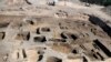 Archaeologists observe the site where they discovered 63 mud-brick tombs at the Tell al-Deir necropolis, in the Nile Delta town of Damietta, about 125 miles (200 km) north of Cairo, Egypt. (Egypt's Supreme Council of Antiquities via AP)