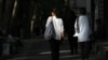 Iranian women not wearing their mandatory headscarves, or hijab, walk in Tehran, Iran, Aug. 5, 2023. 