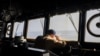 FILE - A crew member observes from the bridge of the USS Gravely destroyer in the south Red Sea, Feb. 13, 2024. Greek-flagged oil tanker traveling through the Red Sea came under repeated attack Wednesday, the British military said.