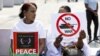 Demonstrators hold signs during a rally on the opening day of peace talks for Sudan at the Place des Nations in front of the European headquarters of the United Nations in Geneva, Aug. 14, 2024.