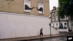 This artwork by the street artist Banksy appeared in west London, Aug. 6, 2024. 