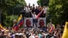 Opposition leader Maria Corina Machado holds a national flag while waving to supporters as she arrives for a rally in Caracas, Venezuela, Aug. 3, 2024.
