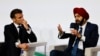 French President Emmanuel Macron (L) looks on as he takes part in a round table discussion next to World Bank President Ajay Banga during the New Global Financial Pact Summit at the Palais Brongniart in Paris on June 22, 2023. 