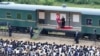 In this photo taken during a two-day trip on Aug. 8 and Aug. 9, 2024, and provided by the North Korean government, North Korean leader Kim Jong Un delivers a speech as he visits a flood-hit area in Uiju, North Phyongan province, North Korea.