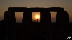 FILE - Revelers gather at the ancient stone circle Stonehenge to celebrate the Summer Solstice, the longest day of the year, near Salisbury, England, on June 21, 2023.